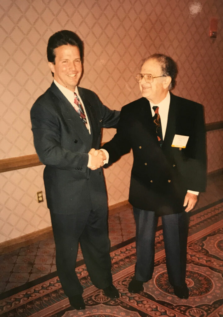 two men in suits shaking hands